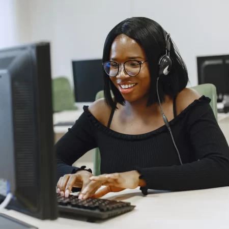 file_african-woman-sitting-computer-science-class-lady-with-glasses-female-student-sitting-computer